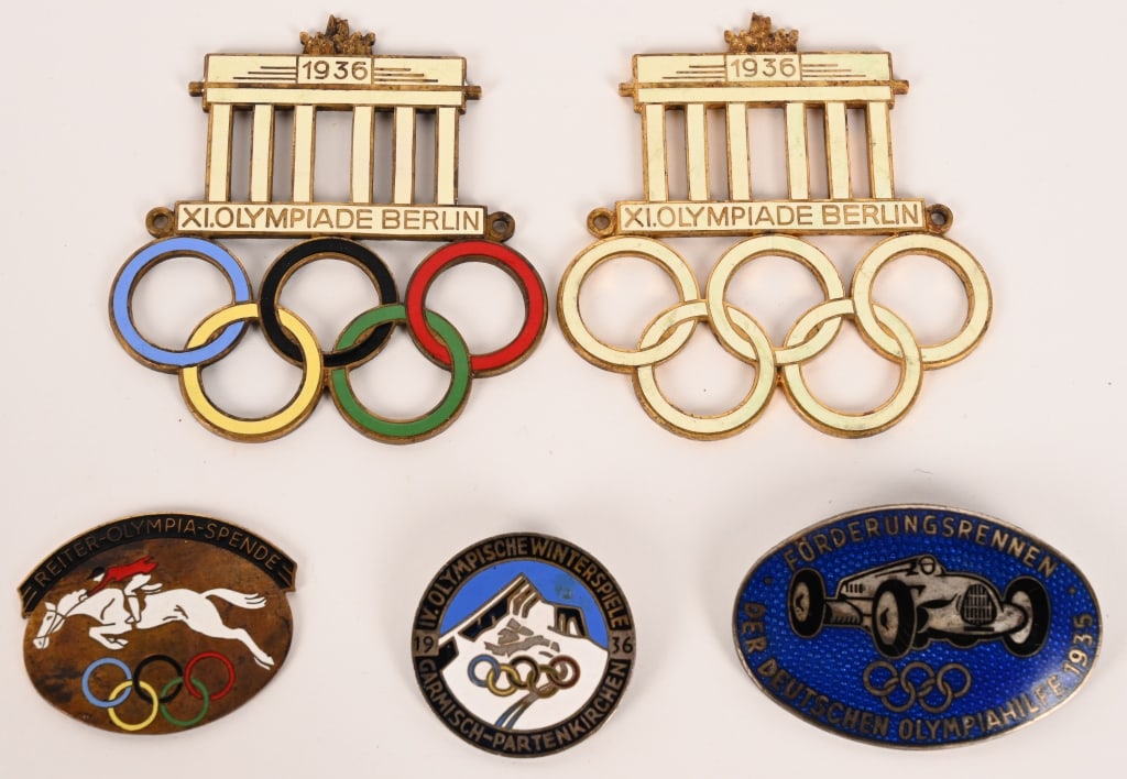 WWII NAZI GERMAN 1936 OLYMPIC GAMES BADGE LOT WW2: Lot of 1936 Olympic Badges to include 1) 1936 XI OLYMPIADE BERLIN CAR BADGE. Fine enamel badge measuring 2 13/16 X 2 15/16 showing the Brandenburg Gate with the colored Olympic Rings in multi color. W