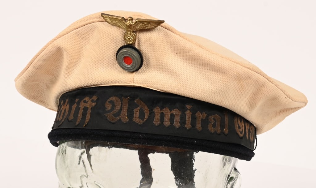 GERMAN KRIEGSMARINE PANZERSCHIFF GRAF SPEE CAP: Private purchase, white cotton construction "Donald Duck" style sailor’s cap features a one piece, circular crown and two piece side panels with machine stitched vertical seams to each side. The