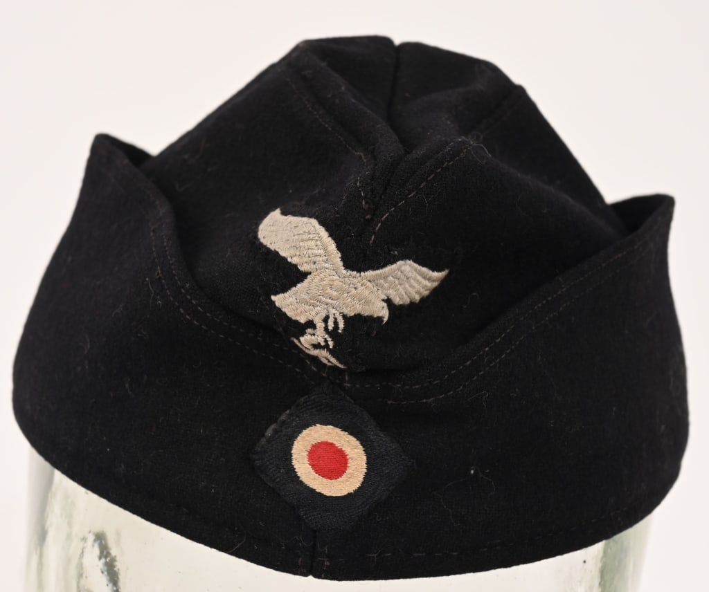 WWII NAZI GERMAN PANZER OVERSEAS CAP WW2: German Luftwaffe “Other Ranks” Overseas Cap for Panzer or Mech. This cap is produced in black wool. The front peak has a hand-applied, machine embroidered Luftwaffe eagle in silvery-gray c