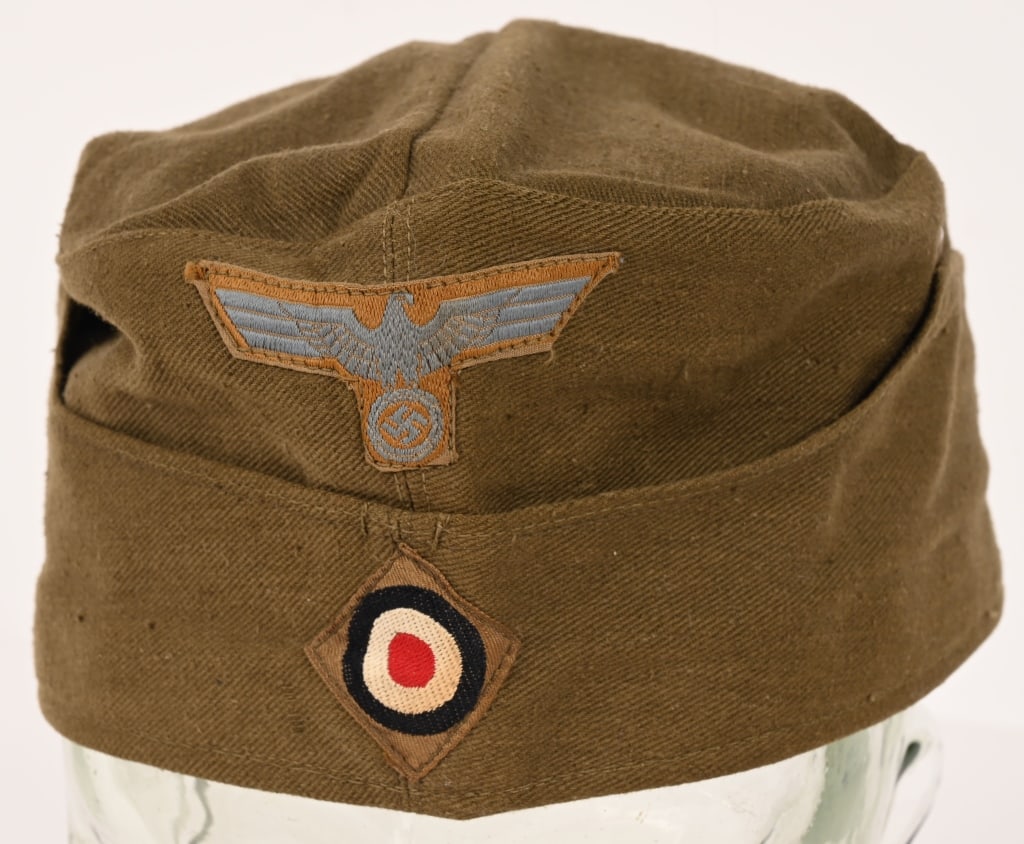 WWII NAZI GERMAN EM/NCO'S TROPICAL OVERSEAS CAP: Ribbed olive/khaki cotton twill construction cap with fold down side and back panels with gently sloping downward scallops to the front and the forward sides. As is typical the fold down panels are st