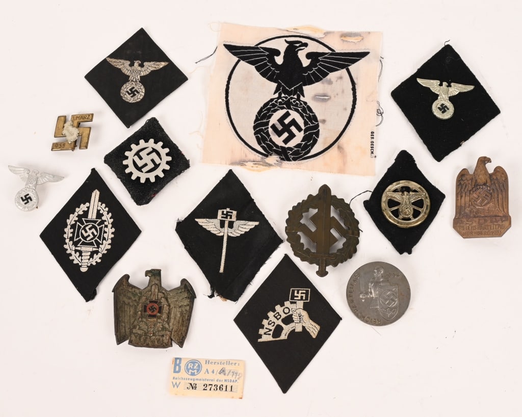 WWII NAZI GERMAN SLEEVE DIAMOND & BADGE LOT NSDAP: WWII Nazi German cloth and badge lot to include 1) 1927 PATTERN POLITICAL CAP EAGLE. An early, stamped alloy eagle, whose outstretched wings have a span of 37mm, and which clutches a wreathed, mobile