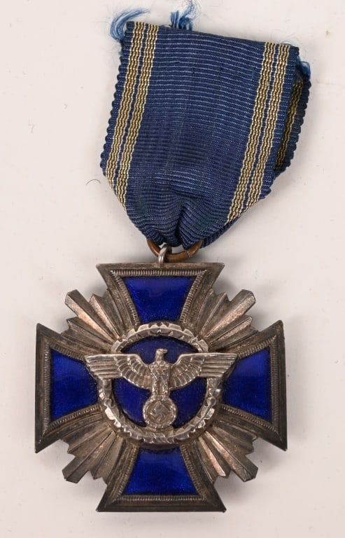 WWII NAZI NSDAP FIFTEEN YEAR LONG SERVICE AWARD: Second class, three piece construction, die struck, alloy award, with a nickel/silver plating and royal blue enamel work. Award in the form of a cross Pattée with central circular centerpiece and