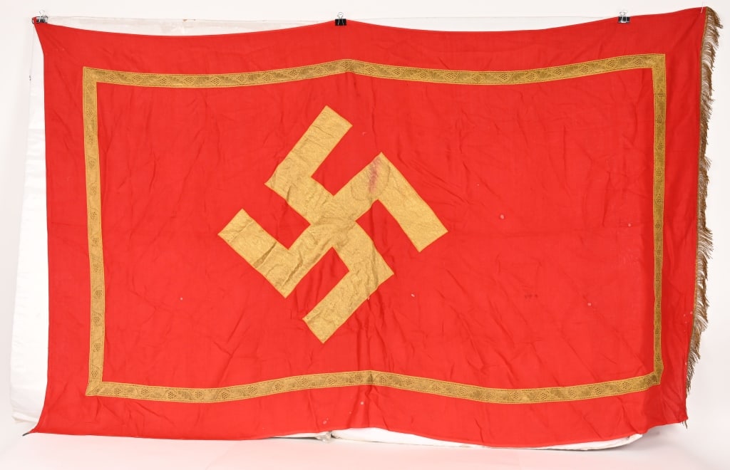 WWII NAZI GERMAN NSDAP POLITICAL PODIUM BANNER WW2: Approximately 51 X 80 inches excluding fringe is single sided multi-piece cotton/rayon construction banner features a red base field with a separate gold bullion canted swastika. The banner also has a