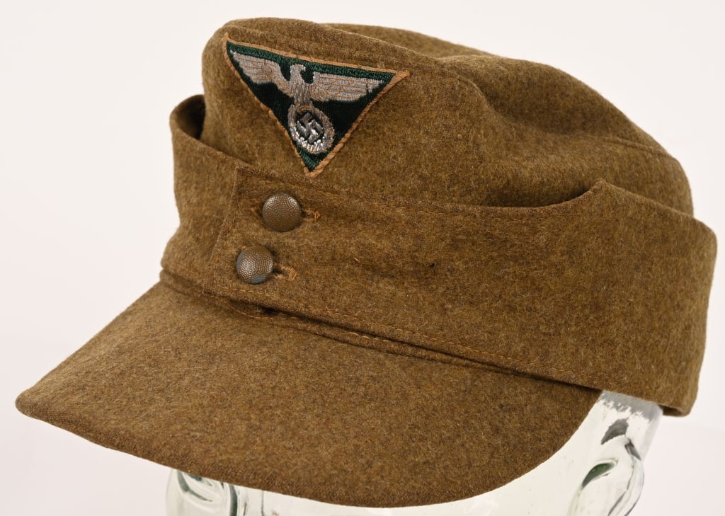 WWII NAZI GERMAN SA M43 SERVICE CAP OR HAT WW2: Sturmabteilung Einheitsfeldmütze M43. Constructed of light brown/olive-drab wool. It is fully surrounded by fold-down side panels, scalloped at the front, providing optional ear and neck protecti