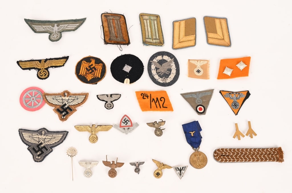 WWII NAZI GERMAN CLOTH AND METAL INSIGNIA LOT: Lot of Nazi German Insignia to include 1) HEER NCO/OFFICER'S BREAST EAGLE. Machine woven, national breast eagle with outstretched wings, clutching a wreathed, canted, swastika in it’s talons in