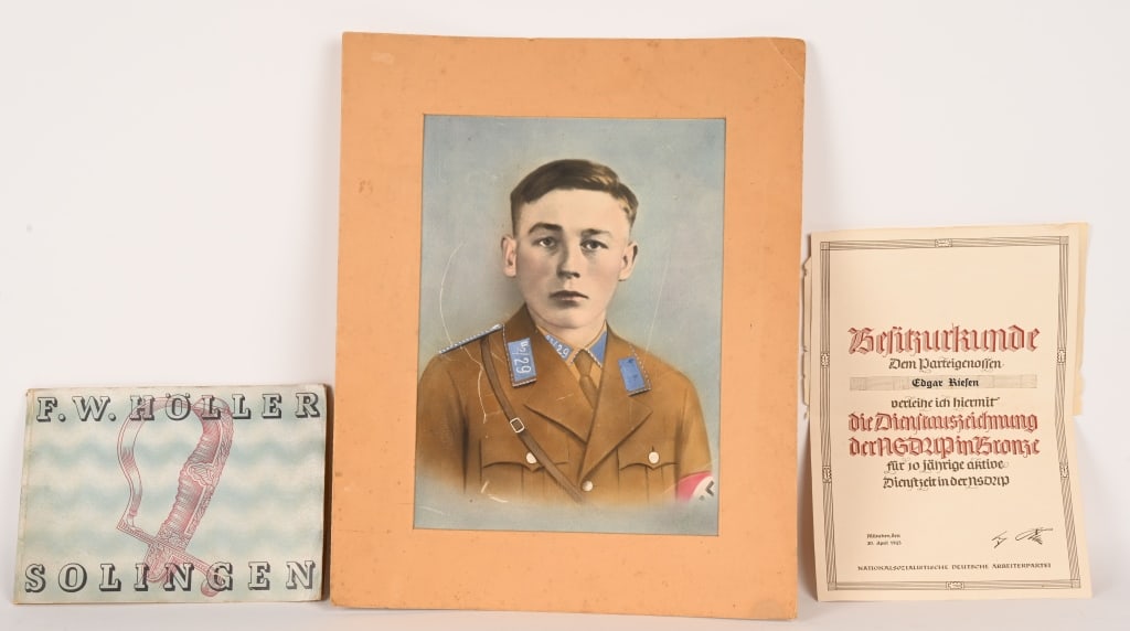 WWII NAZI GERMAN EPHEMERA LOT PORTRAIT DOCUMENT: Lot of Nazi Ephemera to include 1) F.W. HOLLER SOLINGEN CATALOG. Measures 11 3/4 X 8 1/2 inches 28 pages with illustrations. Excellent. 2) PORTRAIT OF A SA MANN. Colorized photo portrait of a member o