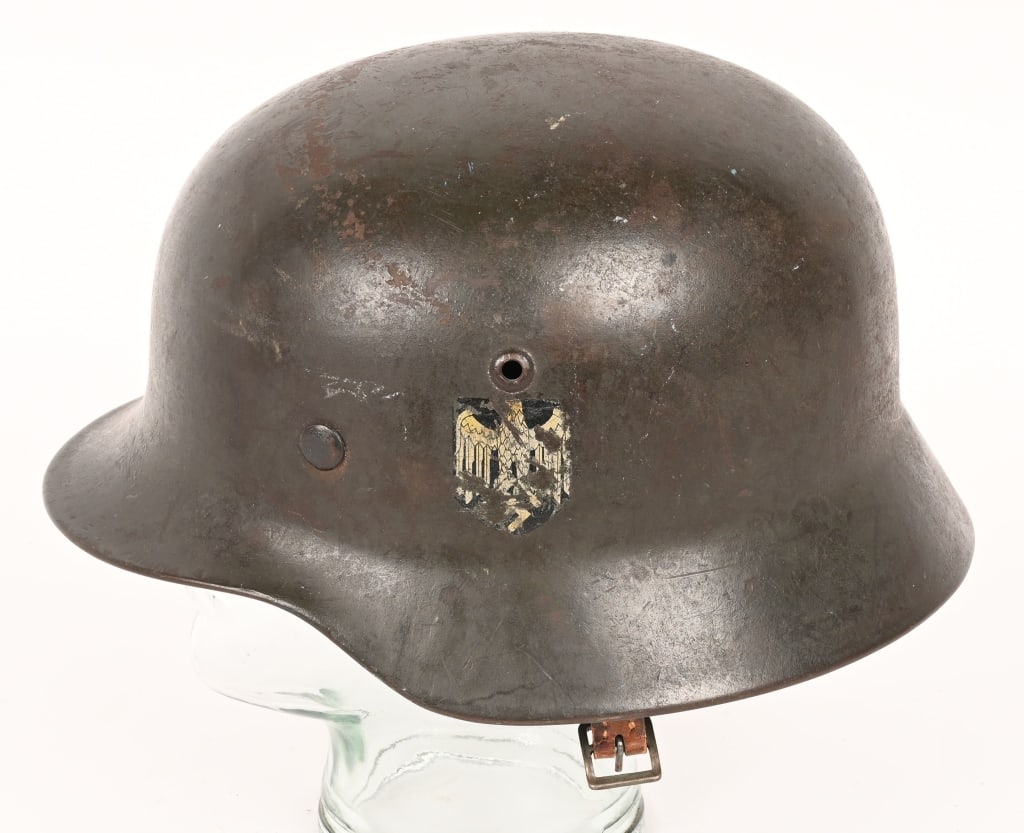 WWII NAZI GERMAN M40 SD ARMY HELMET Q64 WW2: The stamped sheet steel construction helmet retains most of its original paint. The left side of the helmet has a Wehrmacht eagle decal which is retained about 70%. All three liner retaining rivets an