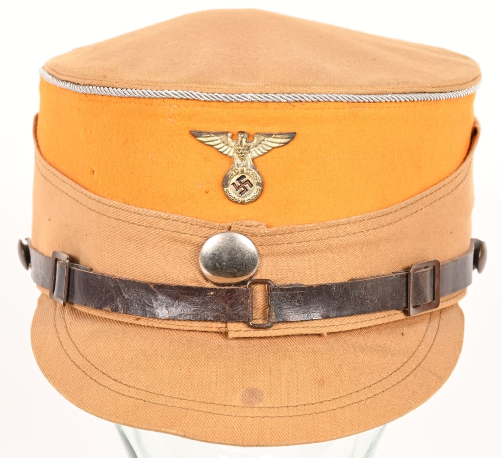 WWII NAZI GERMAN SA GRUPPE MITTE ELBE SERVICE KEPI: A tan cotton twill cap with a flat crown, stiff sides and visor. The wire-stiffened edge of the crown is piped in the same material, and there are two metal ventilation grommets just below the crown o