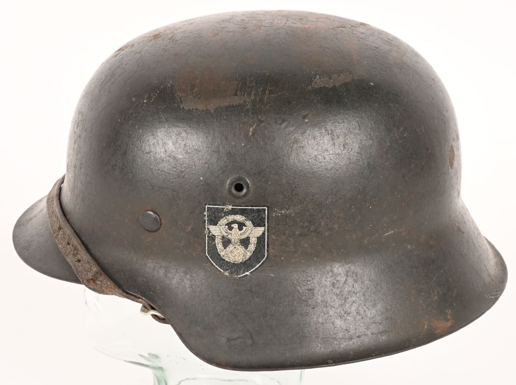 WWII NAZI GERMAN POLICE DD M42 COMBAT HELMET WW2: The stamped, sheet steel construction helmet M42 retains about 80% of it’s original age and usage darkened and slightly rough textured field-grey paint. The helmet has the fourth and final patte