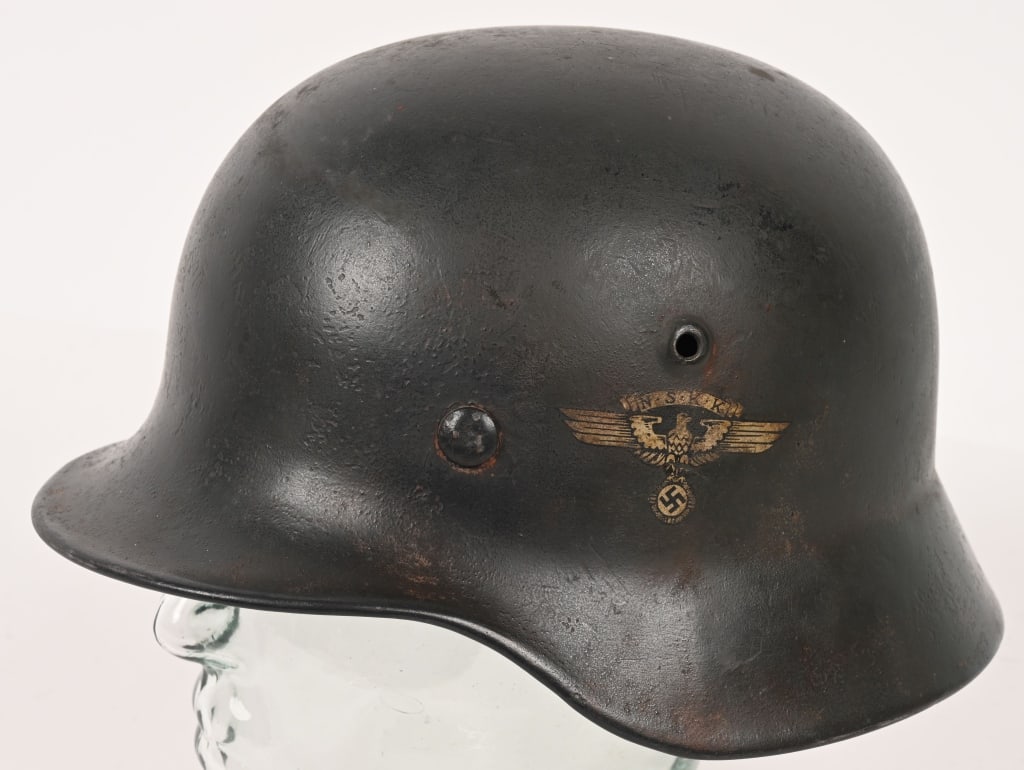 WWII NAZI GERMAN NSKK MODEL 35 COMBAT HELMET WW2: One of the very difficult helmets of the Third Reich to obtain is the NSKK helmet size SE62. This is an NSKK Luftwaffe Brigade helmet having most of its original darker shade of Luftwaffe blue finish.
