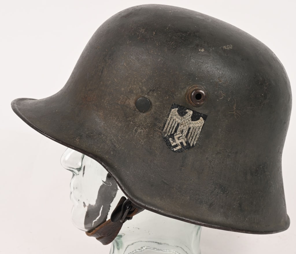 WWII NAZI GERMAN SD M16 TRANSITION HELMET WW2: The stamped sheet steel construction M16 helmet retains almost 100% of its green, transitional over-paint. The left side of the helmet has an Wehrmacht eagle decal which is retained about 95%. The hel