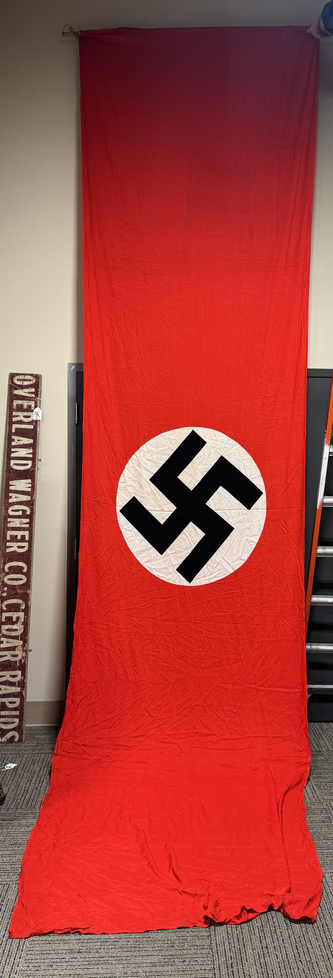 WWII NAZI GERMAN NSDAP FLAG OR BANNER WW2: Roughly 60 X 112 inches and is double sided, cotton construction banner or flag. The flag features a red base field with a separate central white circular disk with a printed canted black swastika to