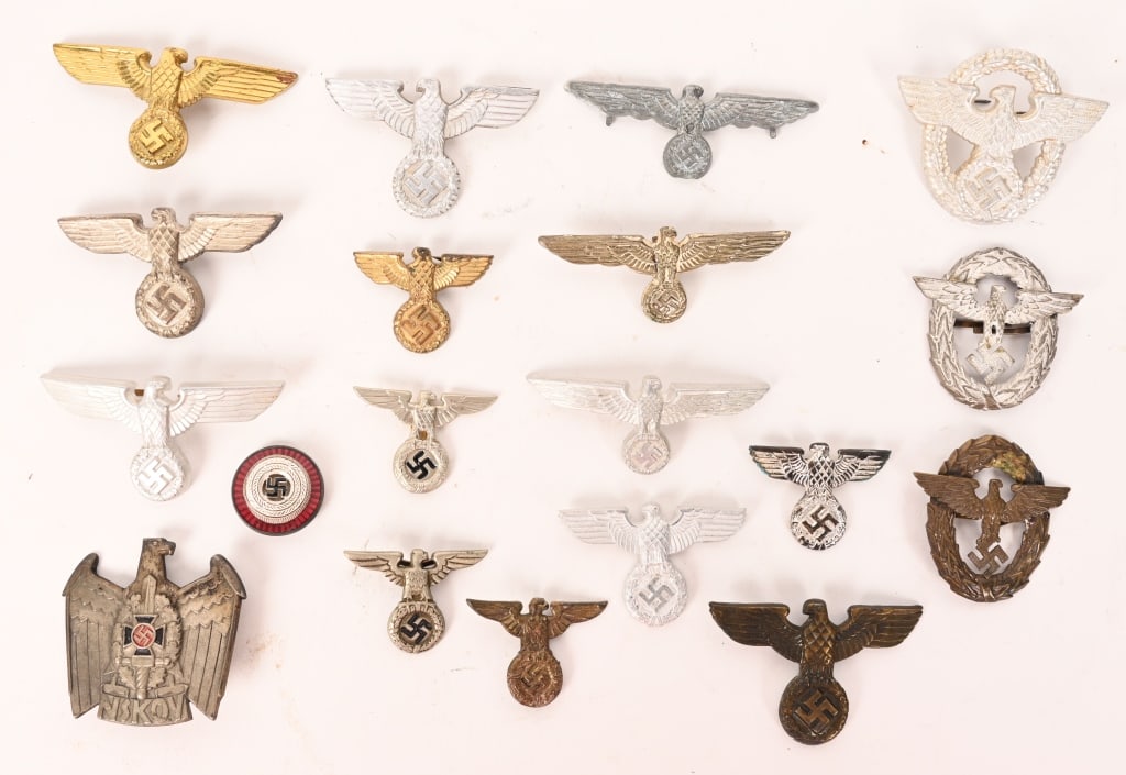 WWII NAZI GERMAN VISOR CAP EAGLE SA POLICE HEER: Lot of 19 Adler's or Eagles and insignia to include Cap badges of the NSDAP, NSKOV, Railway, SA, Police and Wehrmacht. Most retains all of their original pins