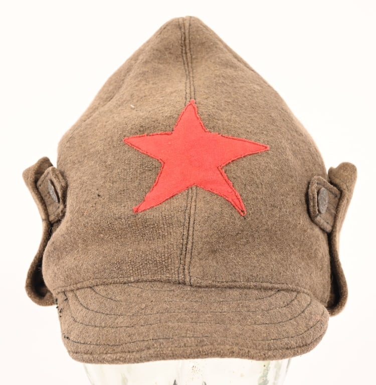 WWII RUSSIAN WINTER BUDIONOVKA PEAKED CAP WW2: Heavy grey/brown wool construction with "button up", fold down side panels. Front visor peak in the same material. Heavy quilted cotton lining. The cap badge is in the shape of a red five pointed star