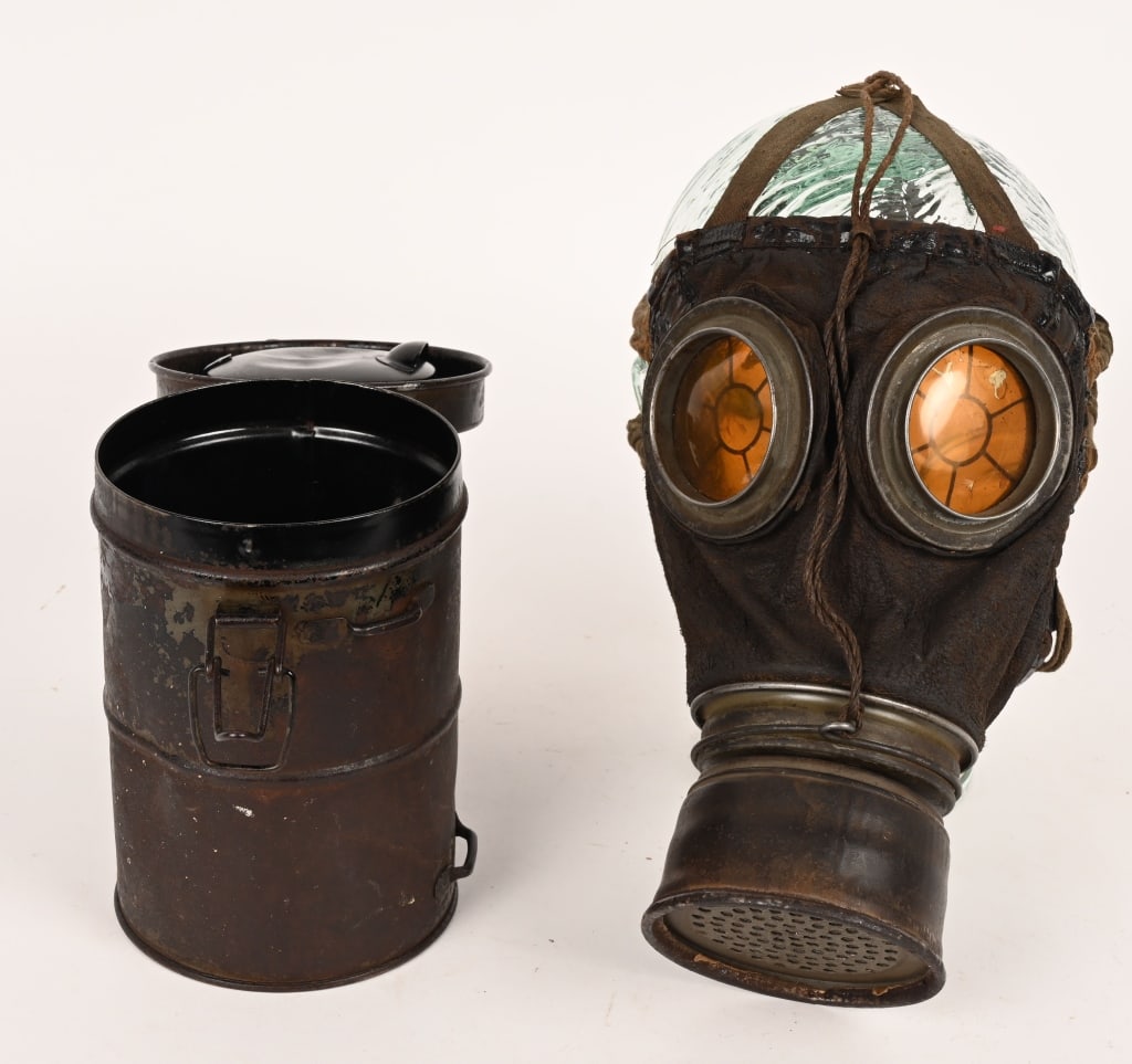 WW1 IMPERIAL GERMAN M1915 GASMASK & CANISTER WWI: The Gummimaske M15 is made of impermeable rubberized cotton fabric. The stamped round metal frames in eyeglasses are made of non-combustible celluloid. The mask is held on the head by two elastic band