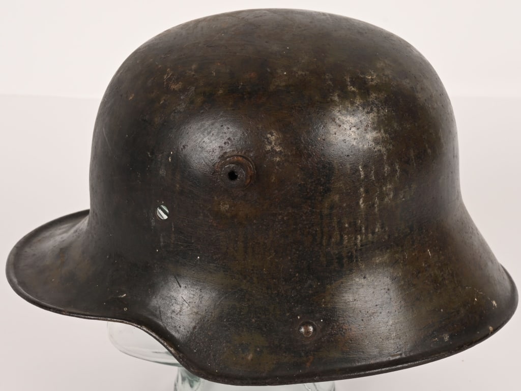 WWI IMPERIAL GERMAN M-16 / M-17 COMBAT HELMET WW1: Imperial German WWI M-16 / M-17 Combat Helmet Shell. The trench helmet is painted with an OD green paint. The inside skirt is maker G. - Gebrüder Gnüchtel A.G., Lauter i./Sa. - (size 62 shel