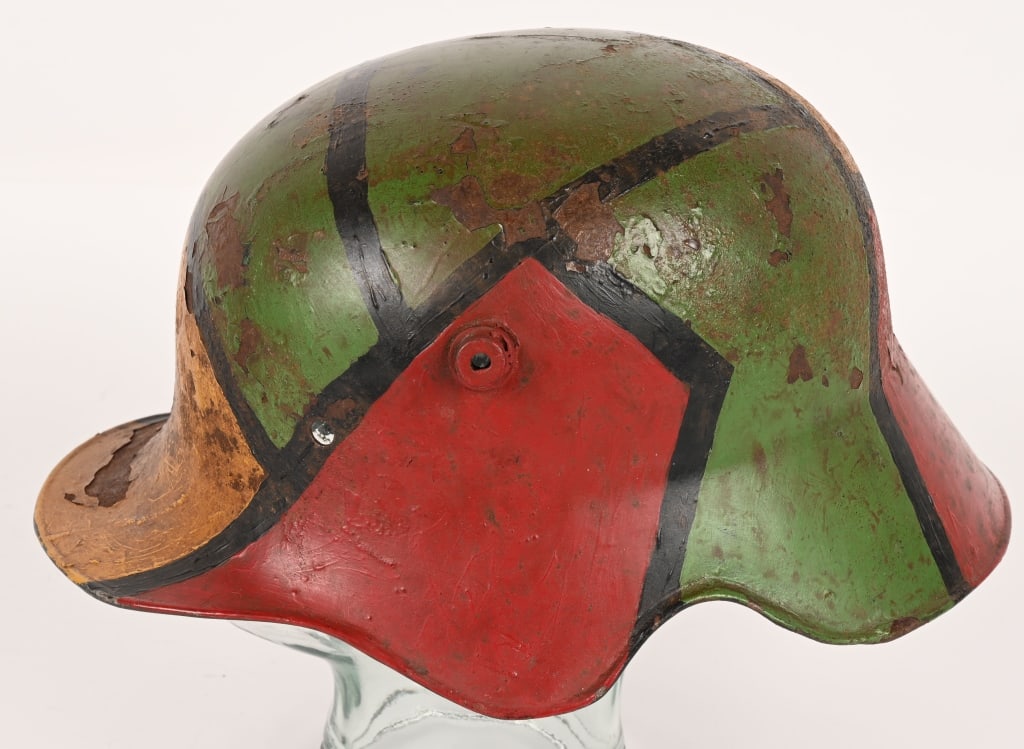 WW1 IMPERIAL GERMAN EAR CUT OUT HELMET CAMO SHELL: The Helmet Ohrenausschnitten or “ear cutout helmet” was a variation of the German Model 1918. It is identical to the standard M18 but for the half-moon curved sections adjacent to the loca
