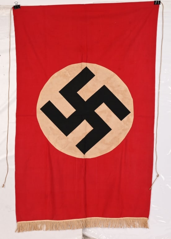 WWII NAZI GERMAN NSDAP POLITICAL PODIUM BANNER WW2: Approximately 30 X 45 inches is single sided multi-piece cotton/rayon construction banner featuring a red base field with a separate canted swastika printed on a white disk. The banner also has white&