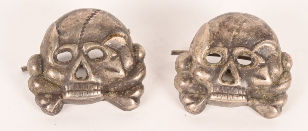 WWII NAZI GERMAN PANZER COLLAR TAB SKULLS WW2: Pair of silver washed, stamped alloy construction, Prussian "Danziger" style skulls and crossbones feature circular eye and triangular nose cut-outs, embossed cranium detailing and dual rows of teeth 
