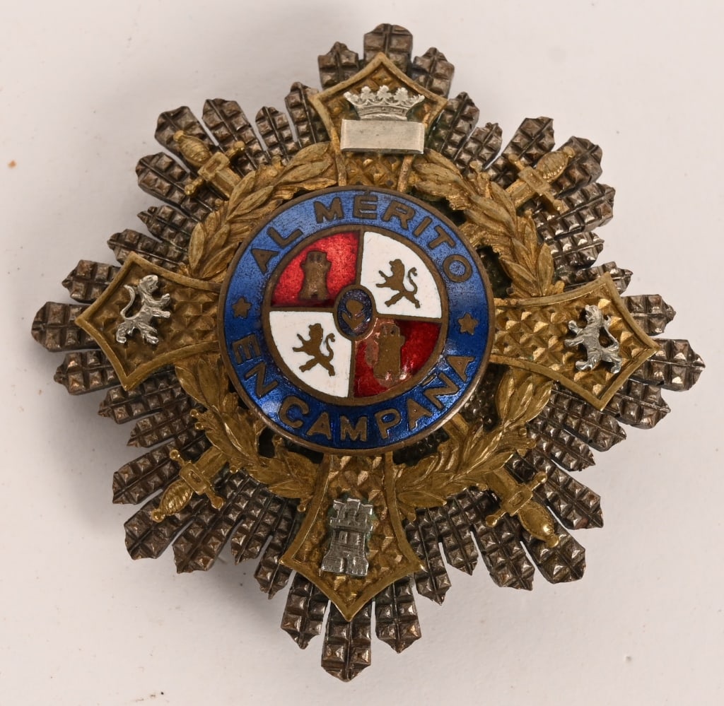 WWII SPANISH WAR CROSS BREAST STAR CONDOR LEGION: Constructed of a silver alloy with multi-coloured enamels, the obverse consisting of a vaulted eight-pointed pebbled star, overlaid by a gilded cross with its arms joined together through the quadrant