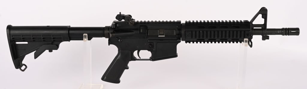 BUSHMASTER XM-15 - E2S SBR CLASS III IN 5.56 MM: SERIAL NUMBER: BFI647850 BARREL: 12" CALIBER: 5.56MM MANUFACTURED: 2000's Metal is standard finish with YHM rear flip up sight. YHM rail system is attached. Standard M4 pistol grip and stock. NO MAGAZ