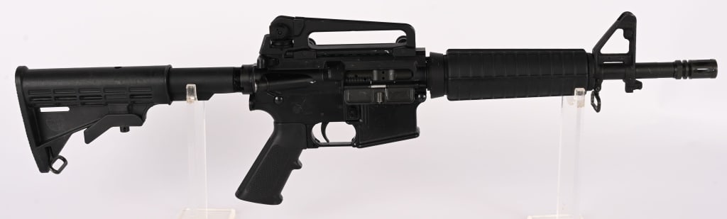 BUSHMASTER XM-15 - E2S SBR CLASS III IN 5.56 MM: SERIAL NUMBER: LBM17436 BARREL: 12" CALIBER: 5.56 MANUFACTURED: 2000's Metal has standard finish with A2 front sight and clamp on carry handle sight. Standard M-4 style Butt stock, forend and pistol g