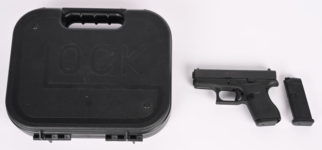 GLOCK MODEL 42 SEMI AUTO PISTOL WITH CASE: SERIAL NUMBER: AAYL2145. BARREL: 3". CALIBER: .380 ACP. Made in the U.S. Factory. It features a white dot front sight and u-notch rear sight, matte black slide and polymer frame. This single stack