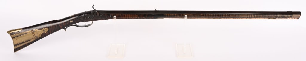 PERCUSSION FULL STOCK RIFLE: SERIAL NUMBER: NSN BARREL: 34 1/2. CALIBER: about .45. Full tiger maple stock with octagon barrel marked "N H" on top flat. The N is backward and there is an etched geometric design around the rear si