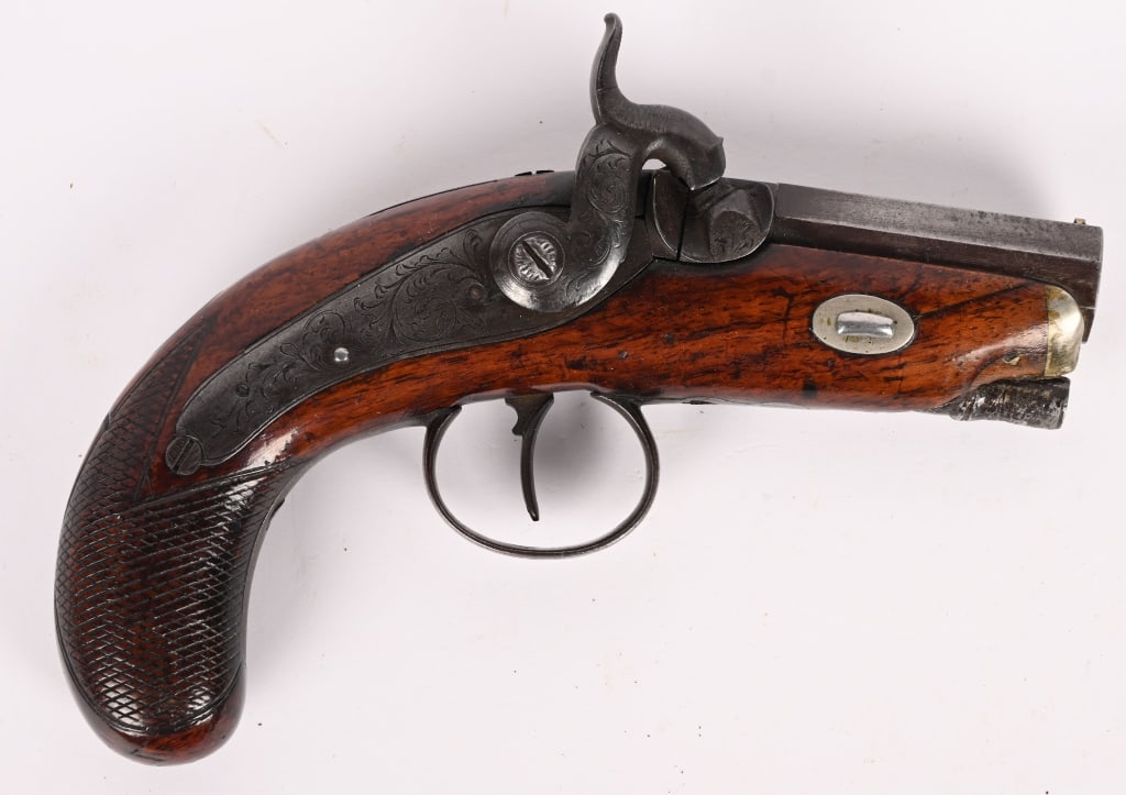 IRISH PERCUSSION DERINGER, NEILL BELFAST: SERIAL NUMBER: N/A. BARREL: 2 3/4"". CALIBER: about .50. MFG: circa 1850. Octagon barrel marked. " Neill Belfast" on top flat. Barrel breech, tang, lock and trigger guard are lightly engraved.