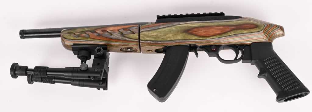 RUGER .22LR CHARGER SEMI AUTO PISTOL: SERIAL NUMBER: 490-66751. BARREL: 10". CALIBER: .22LR. MANUFACTURED: 2010S. Based on the 10/22. Matte blued finish. blued barrel with threads and factory rail, factory green laminate stock with