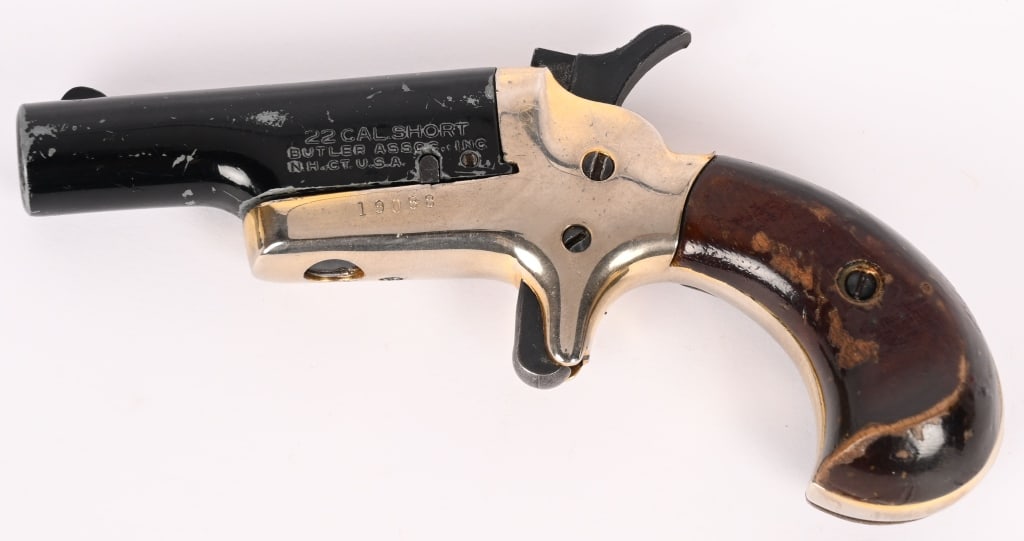 BUTLER .22 SHORT SIGNEL SHOT DERRINGER PISTOL: SERIAL NUMBER: 19088. BARREL: 1 7/16". CALIBER: .22 SHORT. MANUFACTURED: 1970s. Blade front sight. Black barrel with brass frame. Oiled walnut grips. CONDITION: Fair. The frame is slightly faded. The