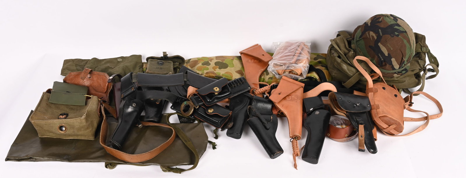 LARGE LOT OF ASSORTED LEATHER & NYLON GEAR: This lot contains soft gun cases, leather re-enactor gear, range bag, a vintage GI helmet, leather holsters,