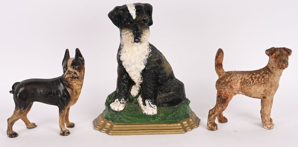 3- CAST IRON DOG DOOR STOPS: Lot of cast iron Dog Door Stops. Includes Terrier, Boston Terrier, and Fluffy Dog. All in great shape. Largest 13" Excellent
