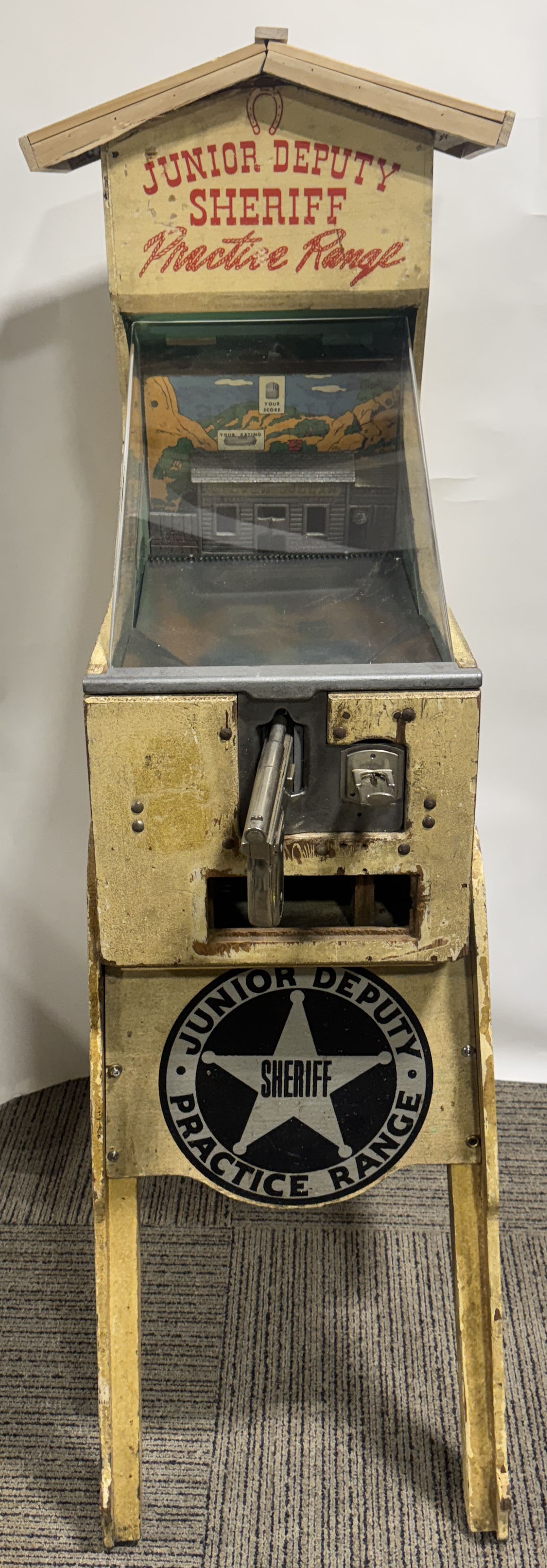 JUNIOR DEPUTY SHERIFF PRACTICE TARGET RANGE: Junior Deputy Sheriff Practice Target Range Shooting Game. Mostly original condition. Missing front door. Roof is replaced. Needs some adjustment to operate. 64"x52"x20" Very Good This is not a