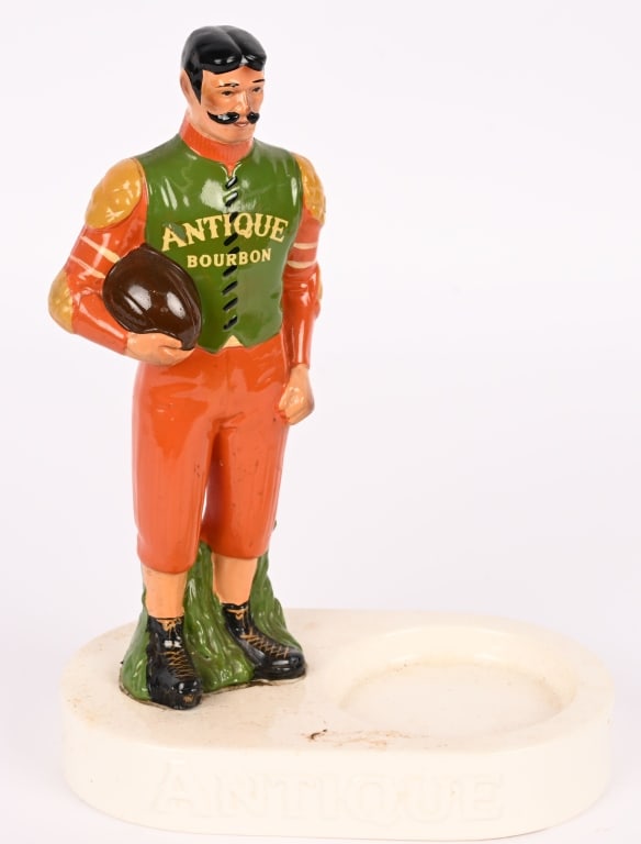 ANTIQUE BOURBON PORCELAIN BOTTLE DISPLAY: Antique Bourbon porcelain Bottle Display. Great early Football Player. Marked Japan. 11" Excellent