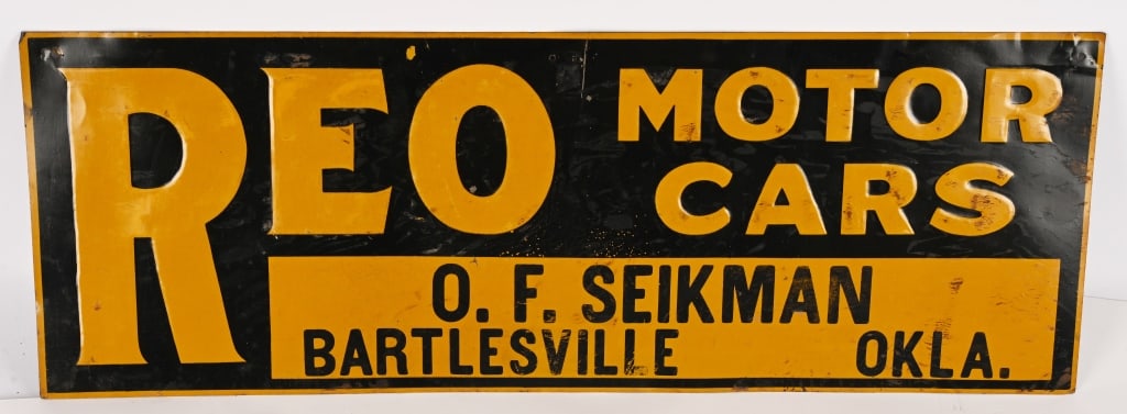 REO MOTOR CARS EMBOSSED TIN SIGN: SST REO Motor Cars embossed tin Sign. All original with advertising for O.F. Seikman Bartlesville, Okla. Nice condition with some rubs. 27 3/4"x10" Excellent