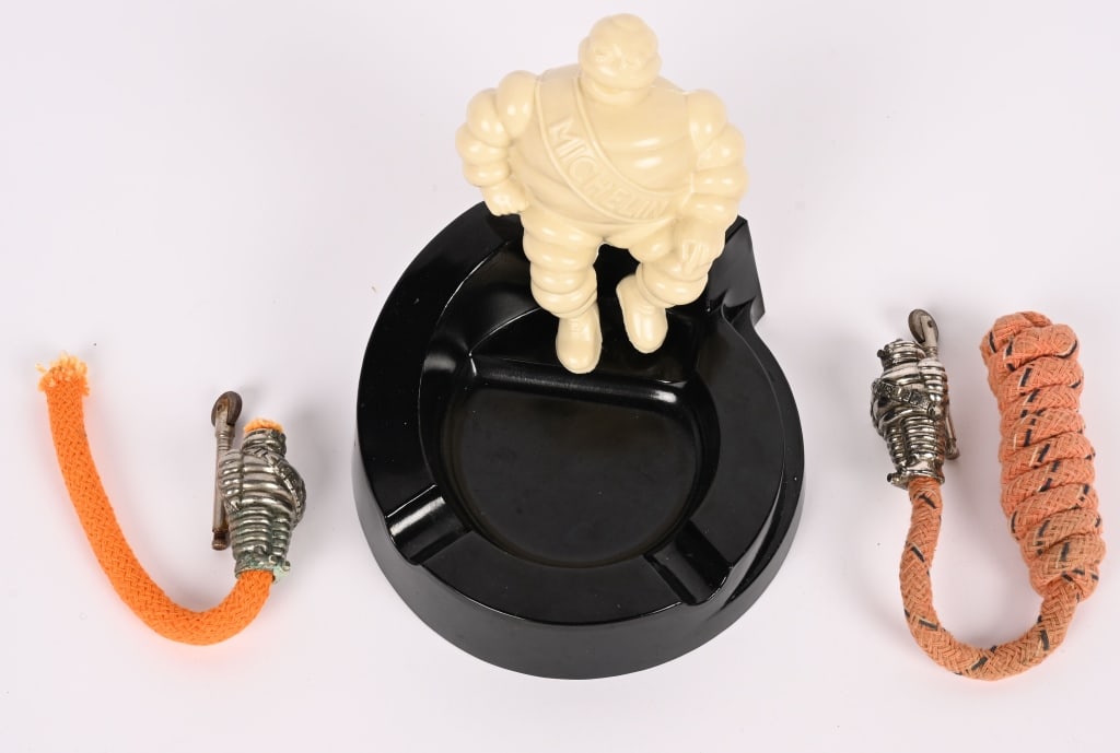 2-MICHELIN MAN BIDENDUM ROPE LIGHTERS & ASHTRAY: Lot includes 2- French Michelin Man Bidendum Rope lighters along with a figural Michelin Man Bidendum Ashtray. The ashtray is about 5" by 5" Excellent