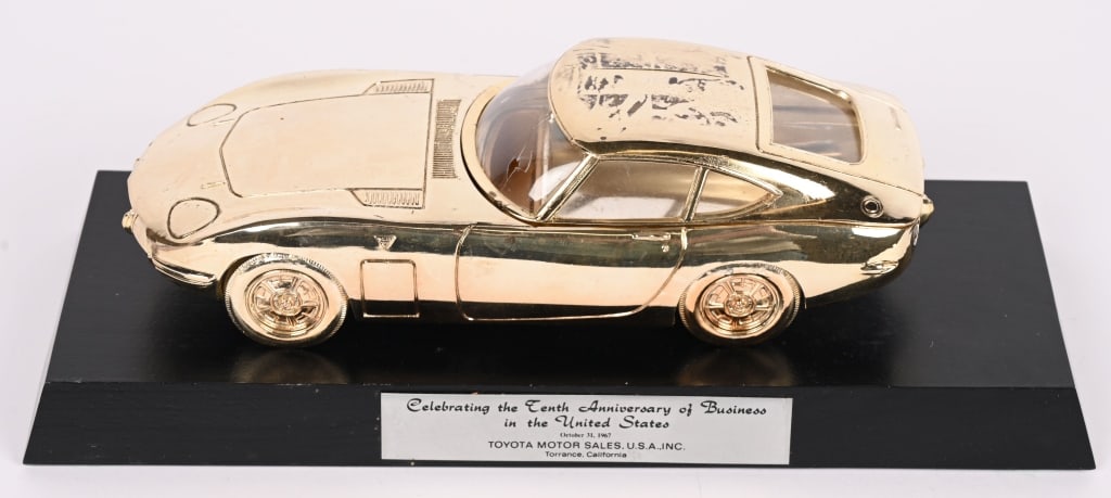 TOYOTA FIGURAL 2000GT CIGARETTE BOX: Great diecast Presentation Cigarette box given to Dealers in 1967 to celebrate the tenth anniversary of business in the USA. This a first run casting which is very detailed. The roof lifts off to