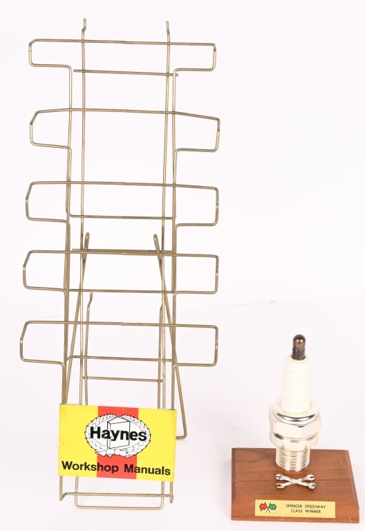 SPENCER SPEEDWAY AWARD & HAYNES MANUAL rACK: Lot includes: 8" Spencer Speedway Class Winner award in the form aof a sparkplug. Marked Awards Trophy Co. Maplewood NJ underneath. 2. 22" Haynes Workshop Manuals wire rack with tin sign. Both are