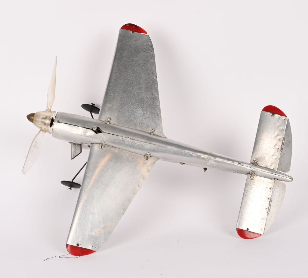 TOPPING 100 CONTROL LINE GAS AIRPLANE: The Topping 100 was introduced in December 1945 by Topping Models, a company based in Akron and Elyria, Ohio. This model was part of a trend in aluminum model airplanes that gained popularity after Wo