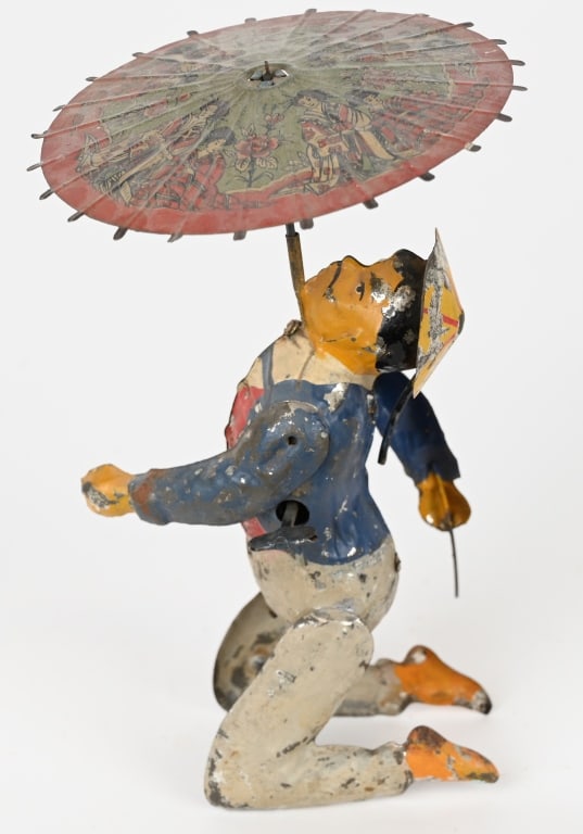 GERMAN HANDPAINTED TIN WINDUP ASIAN & UMBRELLA: Rare early Gunthermann toy that has a handpainted figure with litho umbrella. The umbrella is original but a replacement. Worked when tested. Man flips his arm up and twirls umbrella. Some minor touch
