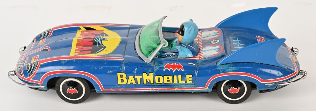 AOSHIN SHOTEN TIN FRICTION BATMOBILE: Japan tin friction Batmobile. Very large and impressive car. Has very nice colors. Has original vinyl Batman Driver. Toy has some spot of loss throughout. Bottom has been repainted. Friction works. A 