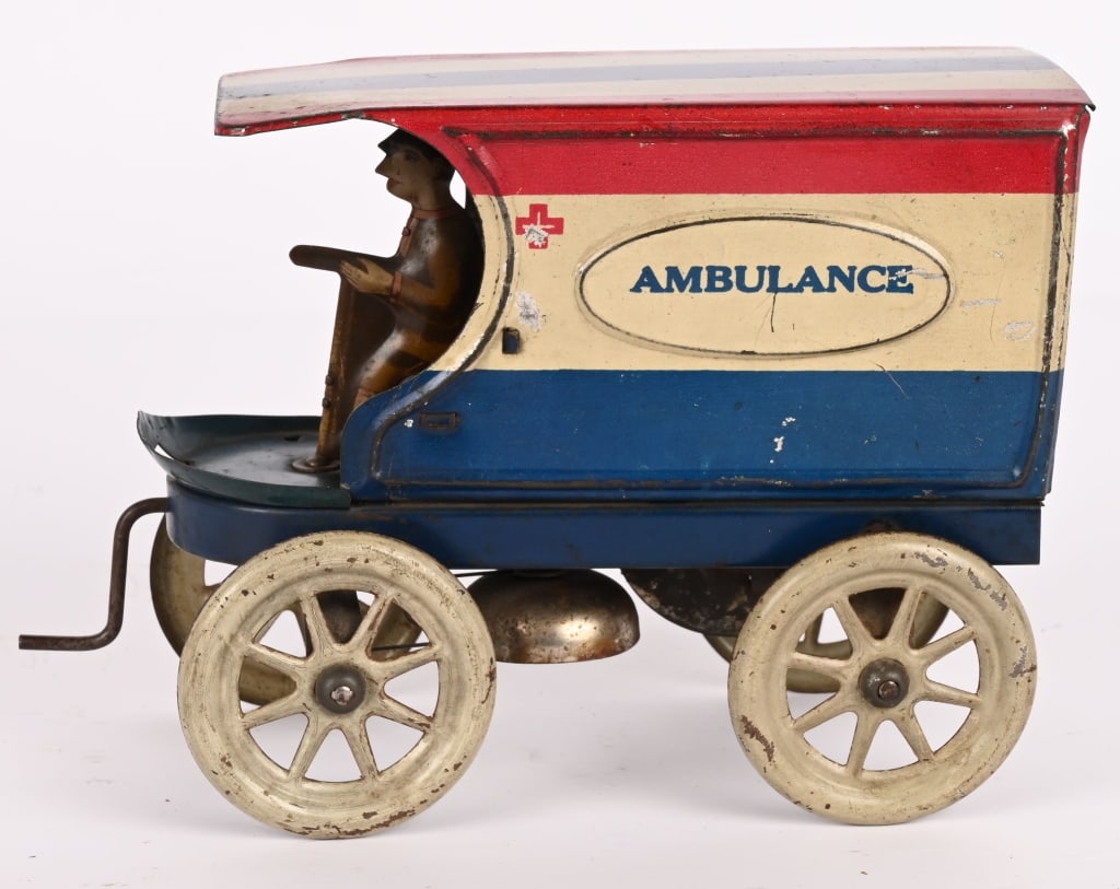 LINDSTROM TIN WINDUP AMBULANCE VAN: Great looking 1920's Lindstrom tin windup Ambulance van in patriotic colors. Crank windup works well. Includes original driver. 8" Excellent