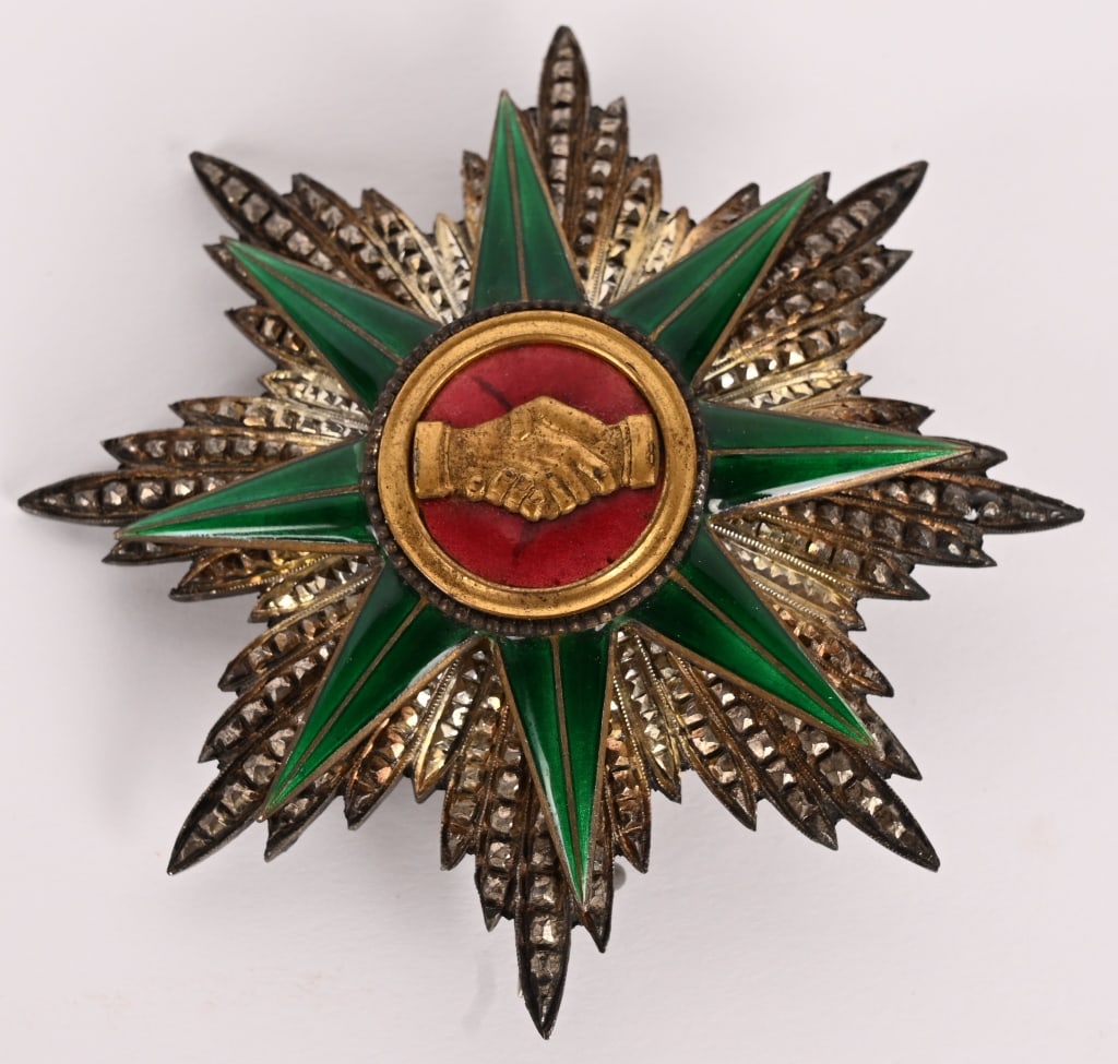 FRENCH OR EUROPEAN BREAST STAR ORDER UNKNOWN: An 8-armed silver breast star of European manufacture, probably French (76.2 by 76.2 millimeters). With a faceted body, a secondary star of dark green enamel and a gilt and enamel centerpiece depictin