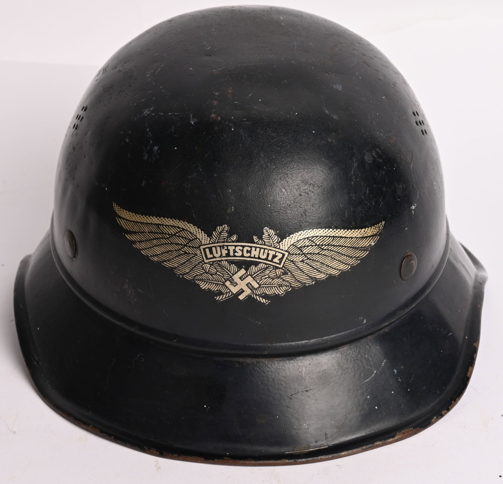 WWII NAZI LUFTSCHUTZ BEADED M38 GLADIATOR HELMET: The three piece, stamped, sheet steel construction Luftschutz M38 "Gladiator" style helmet retains most of its original, smooth, dark satin blue paint. The front center of the helmet has a Luftschutz 