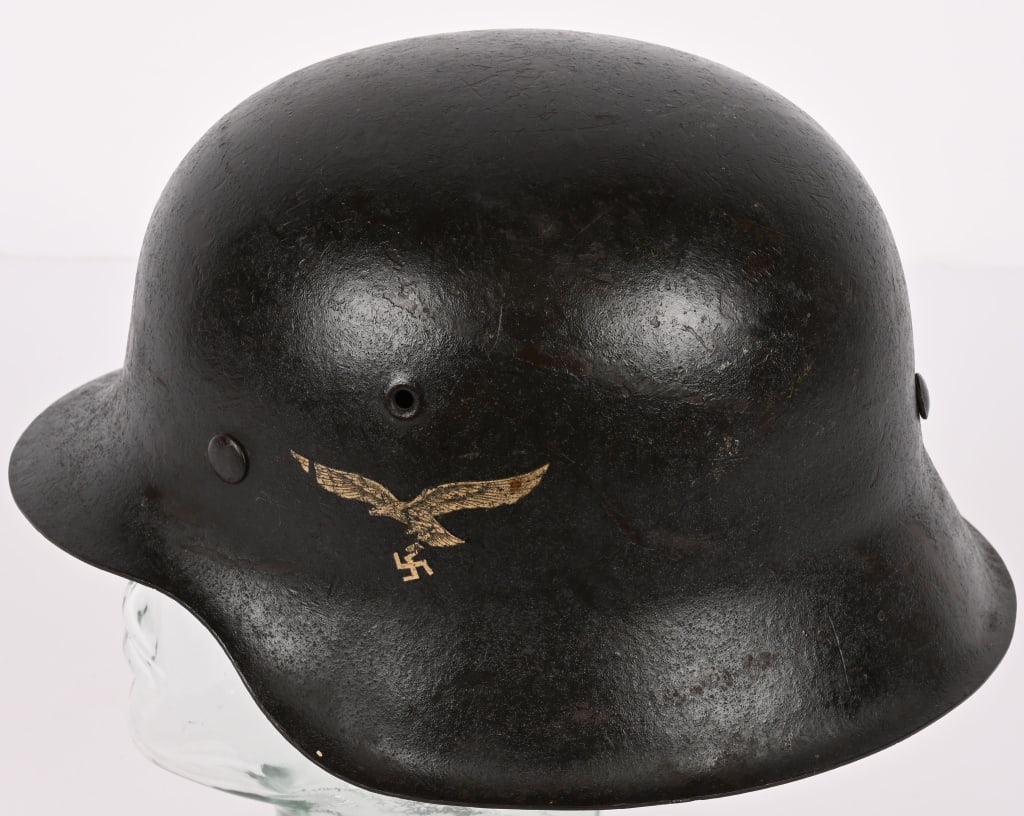 WWII NAZI GERMAN M42 LUFTWAFFE COMBAT HELMET WW2: The stamped, sheet steel construction helmet retains about 95% of its original field-gray paint. The left side of the helmet has a second pattern, (circa 1936/1937 1945), Luftwaffe eagle decal which i