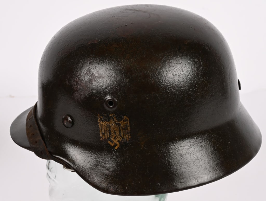 WWII NAZI GERMAN M40 SD WEHRMACHT HELMET W/ LINER: The stamped, sheet steel construction helmet retains most of its factory applied field-gray paint. The left side of the helmet has an Wehrmacht eagle shield decal featuring a eagle with down-swept win