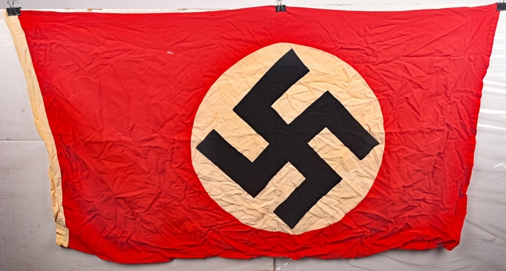 WWII NAZI GERMAN NSDAP NATIONAL FLAG EAGLE M MARKD: Multi-piece cotton construction banner approximately 80cm x 135cm. To both its red fields are white disks with a printed mobile swastikas in black. Shows the expected period use and wear but overall v