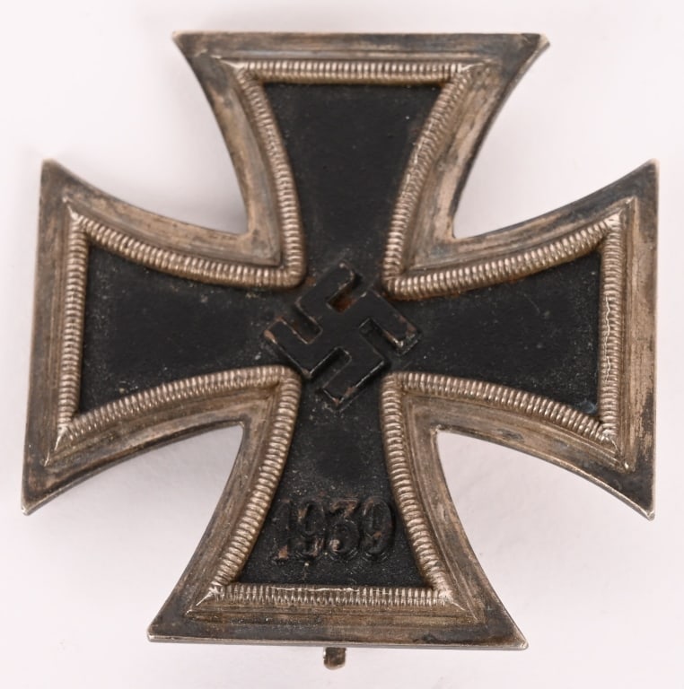 WWII NAZI GERMAN 1ST CLASS IRON CROSS MKD 107 WW2: Die struck alloy construction Patté style cross. Obverse of the award features an embossed central canted swastika and re-institution date, "1939", to bottom arm. Both swastika and date are in ni