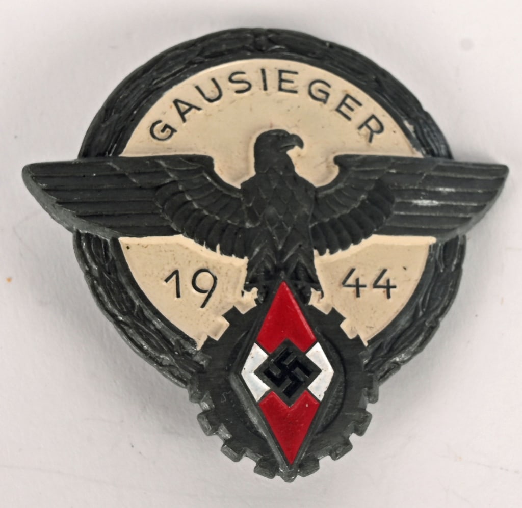 GERMAN HITLER YOUTH GAUSIEGER 1944 AWARD BADGE: WWII Nazi German 1944 Hitler Youth proficiency badge. The badge on the reverse is makers marked G.BREHMER MARKNEUKIRCHEN. The front of the badge retains all of its original finish with minor oxidation